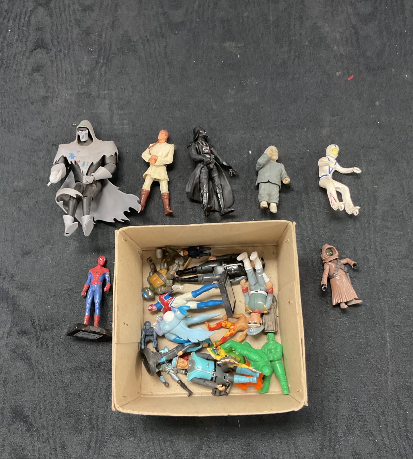 Box of toy figures including star wars