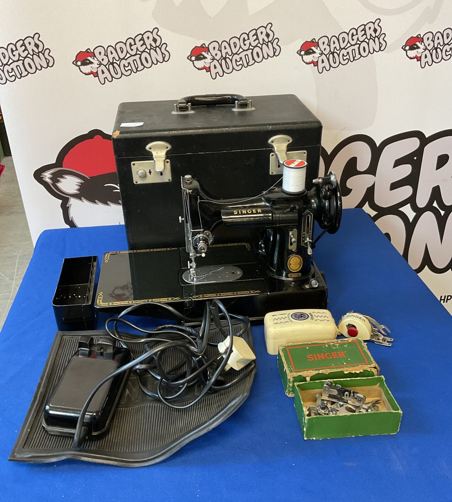 Vintage singer featherweight sewing machine working with accessories