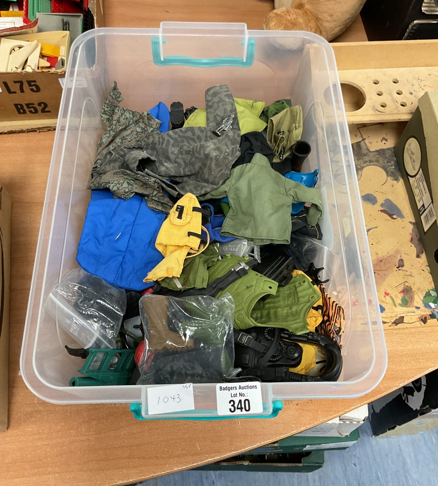 Box of vintage and retro action man clothing