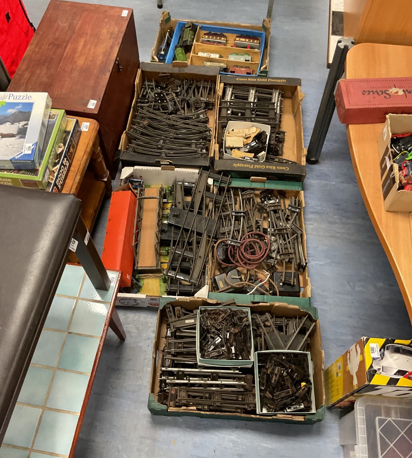 collection of six boxes of Vintage O gauge train sets with trains and rolling stock.