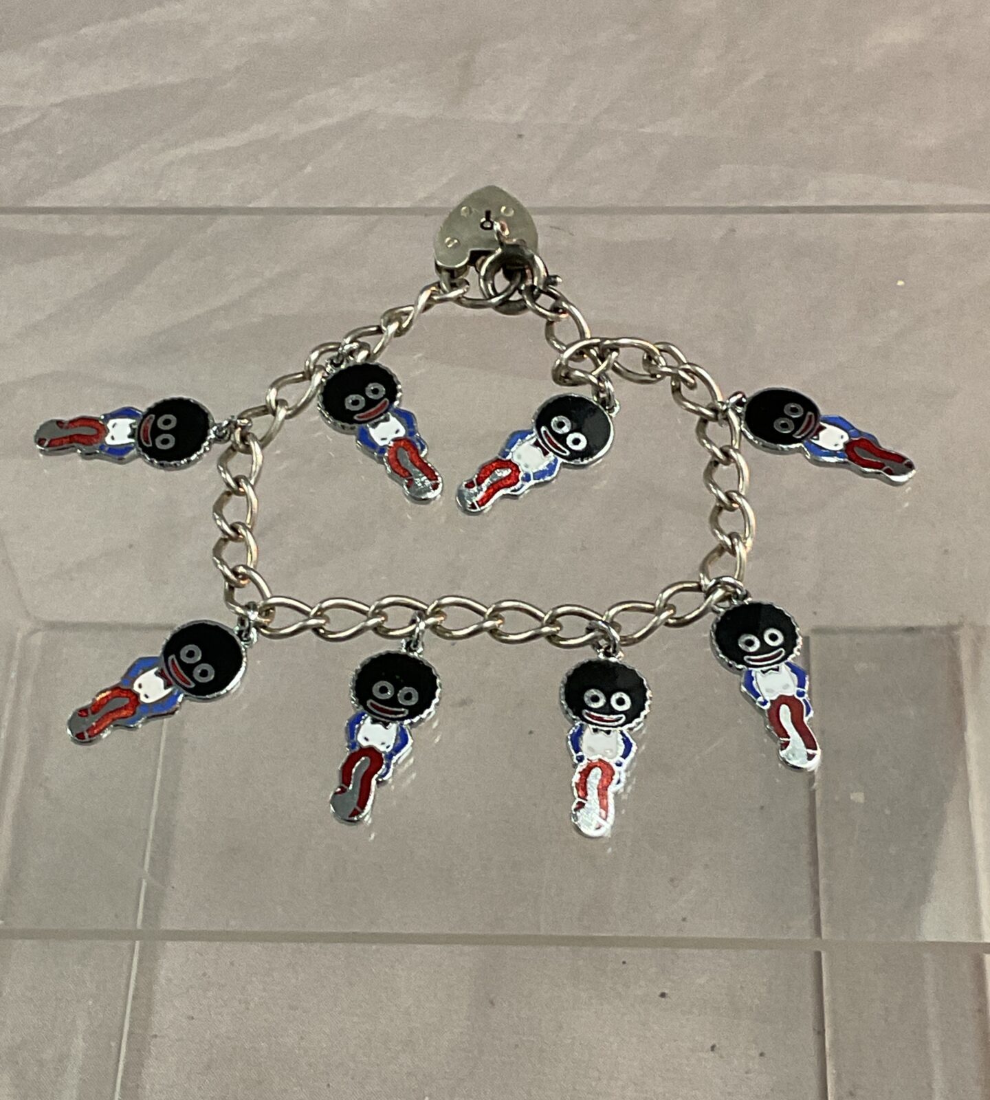 Silver bracelet with eight Robertsons gollies