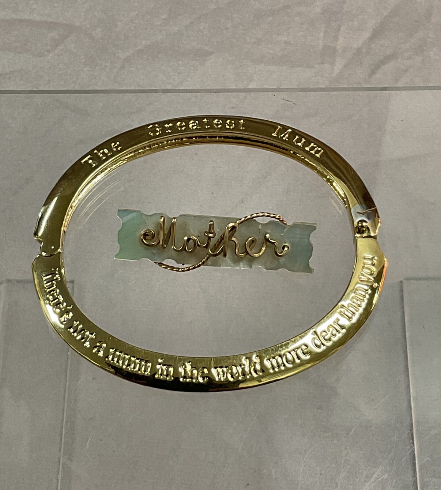 A mother of pearl mother brooch and greatest mum bracelet