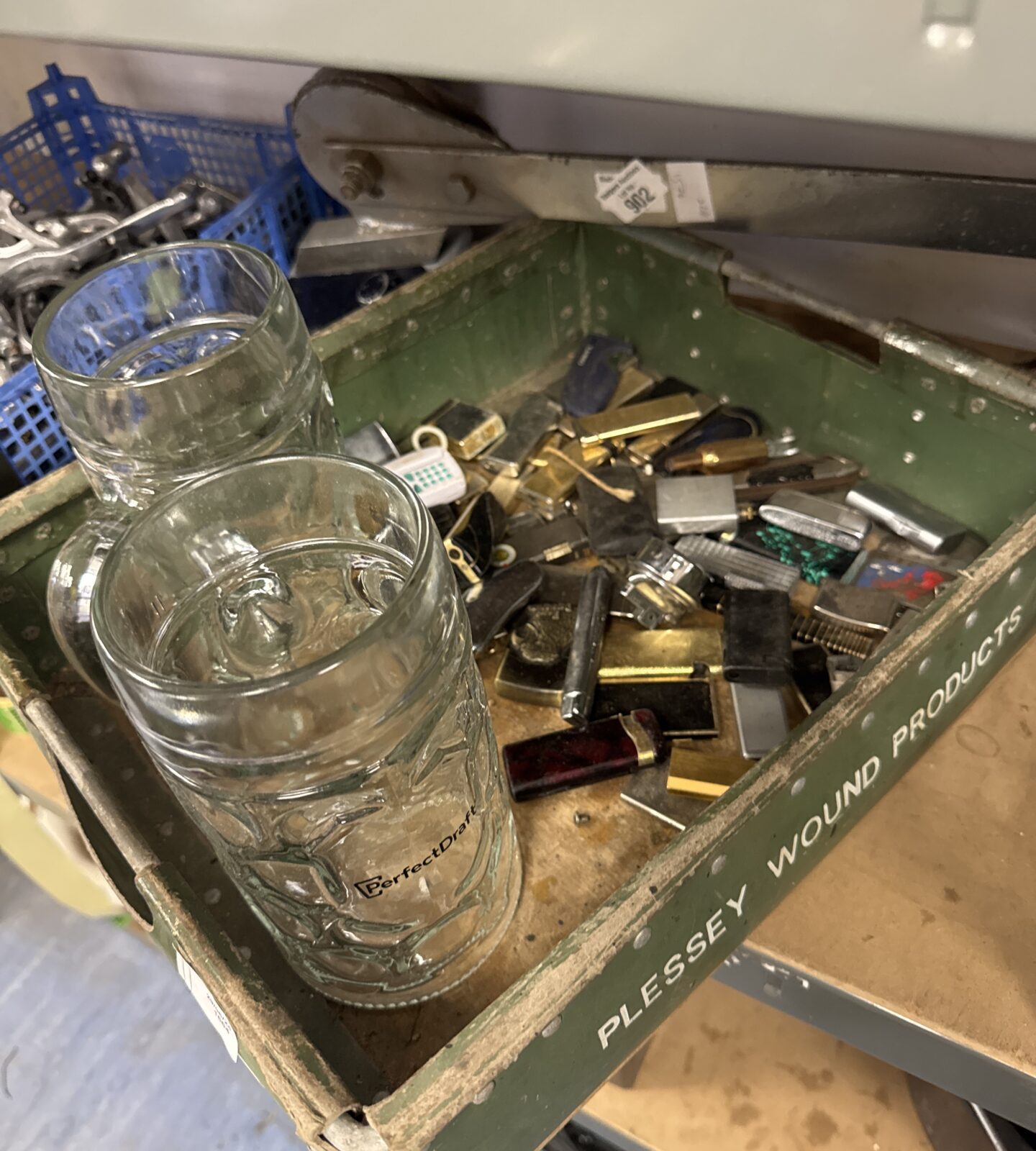 Two large glass steins with tray of lighters inc some novelty