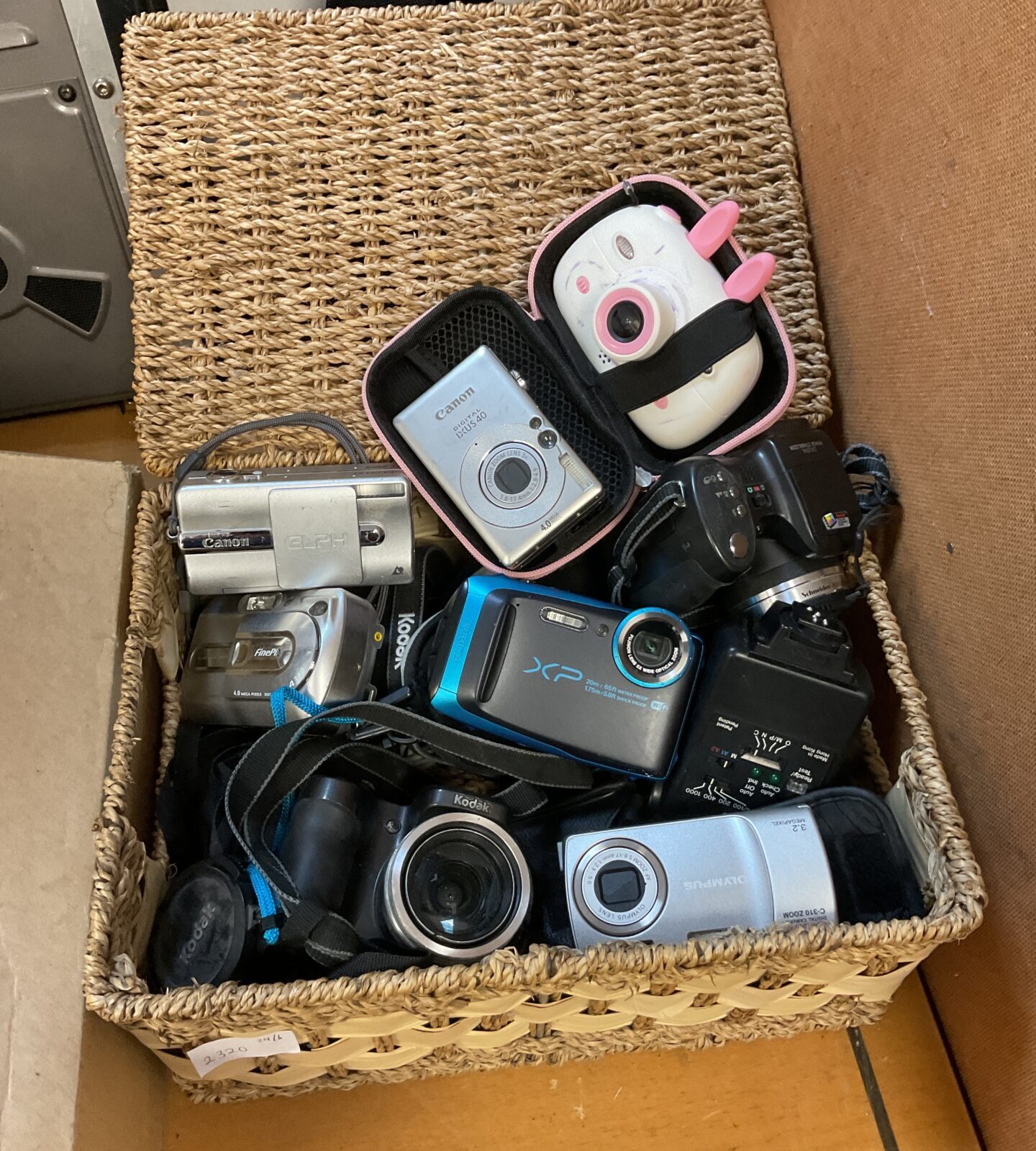 Box of digital cameras inc canon & olympus