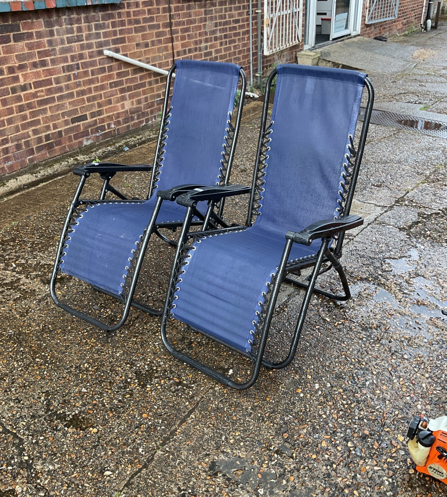 Two blue garden sun loungers