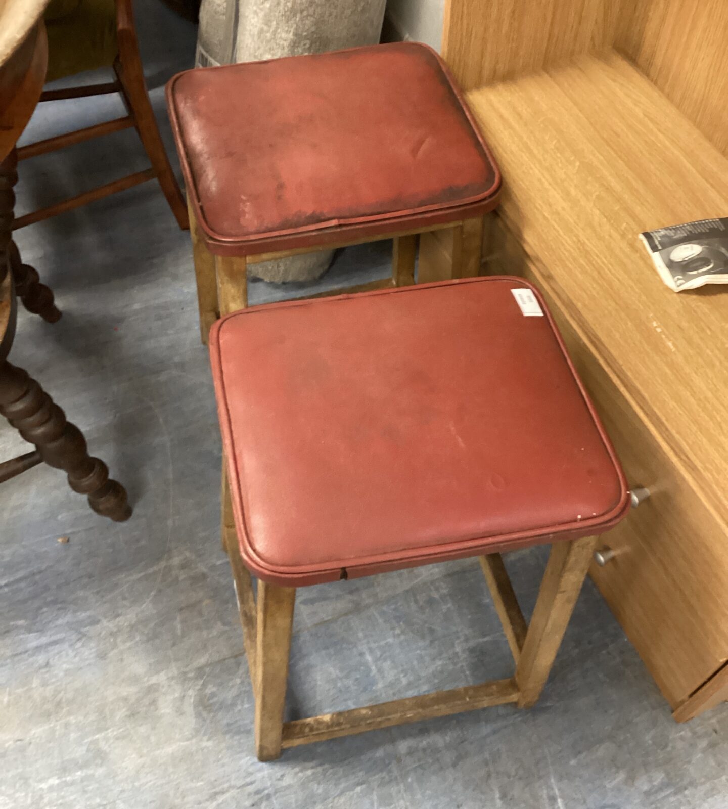 Two wooden leather topped stools