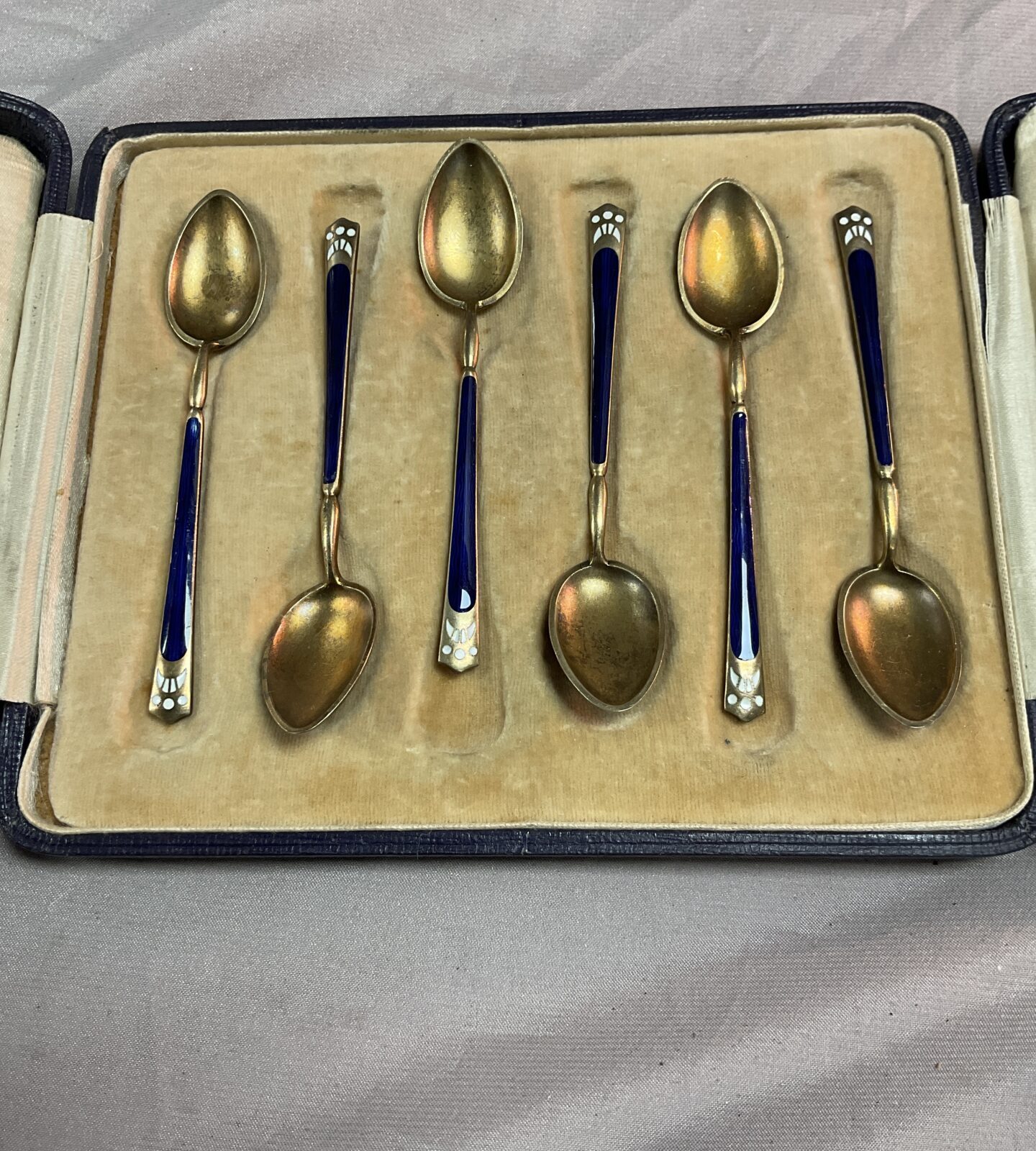 Cased set of 925 Silver gilt enamelled spoons some minor marks