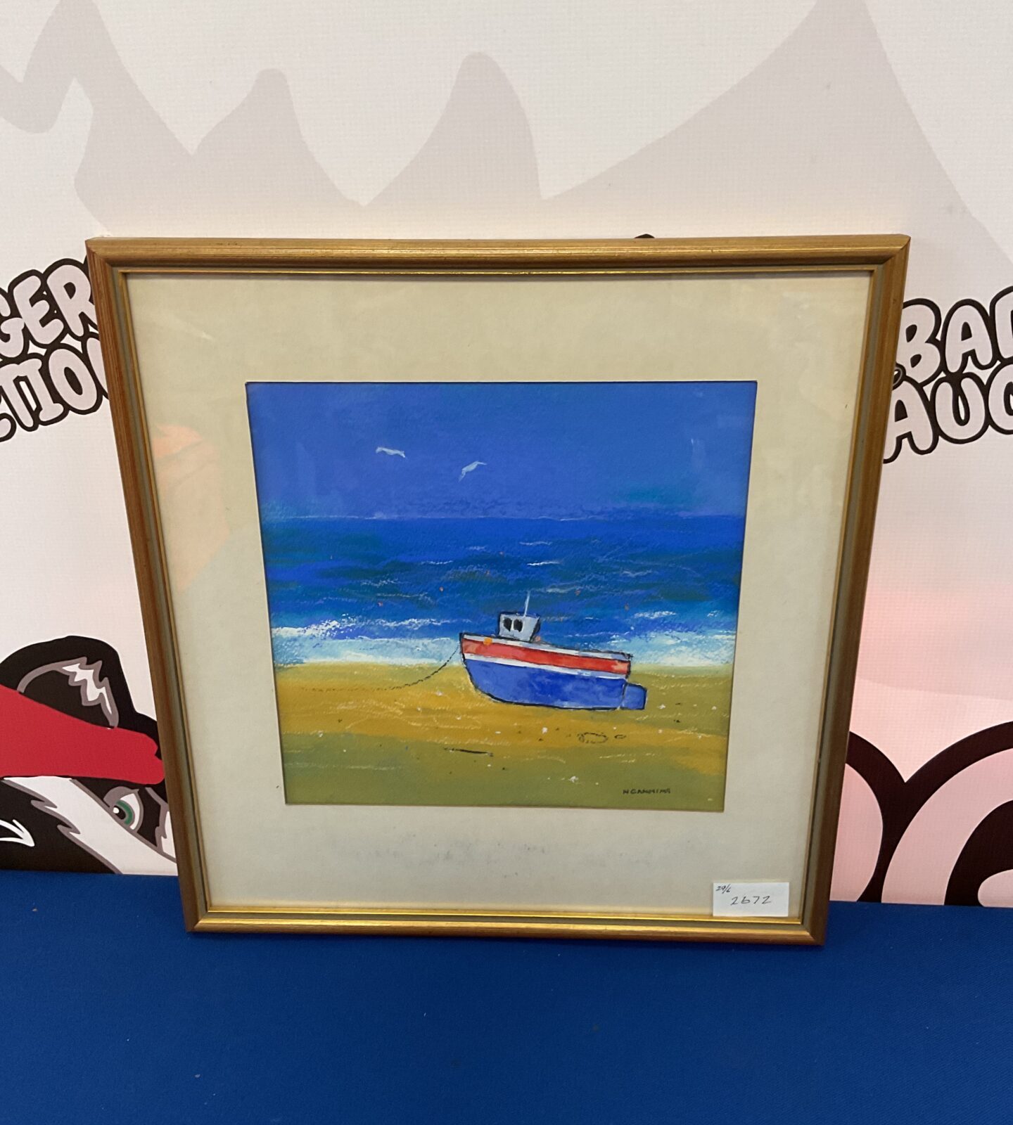 N canning framed oil painting of a boat on beach