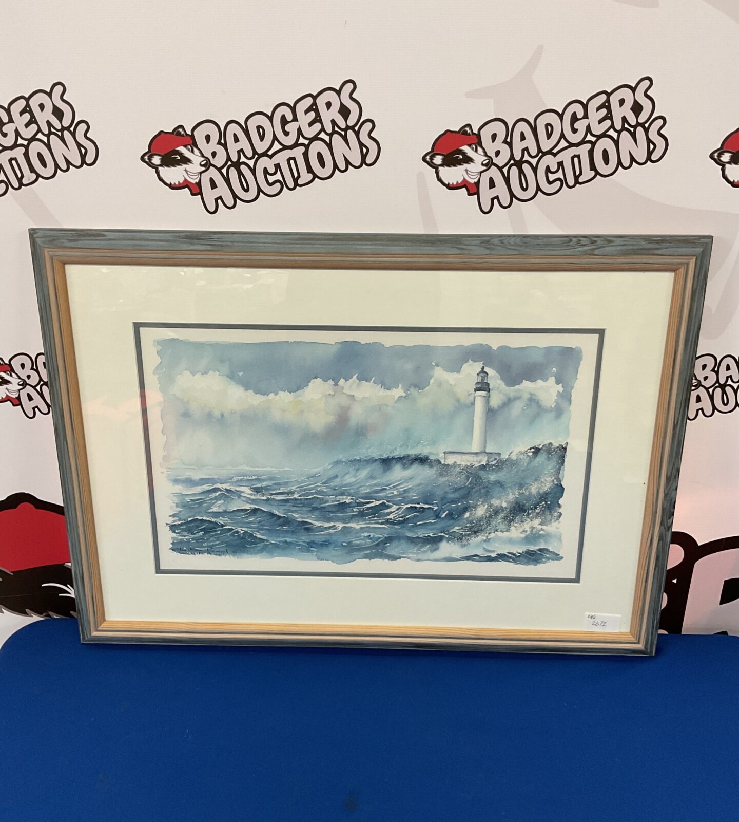 Artist signed watercolour of a rough seascape with lighthouse