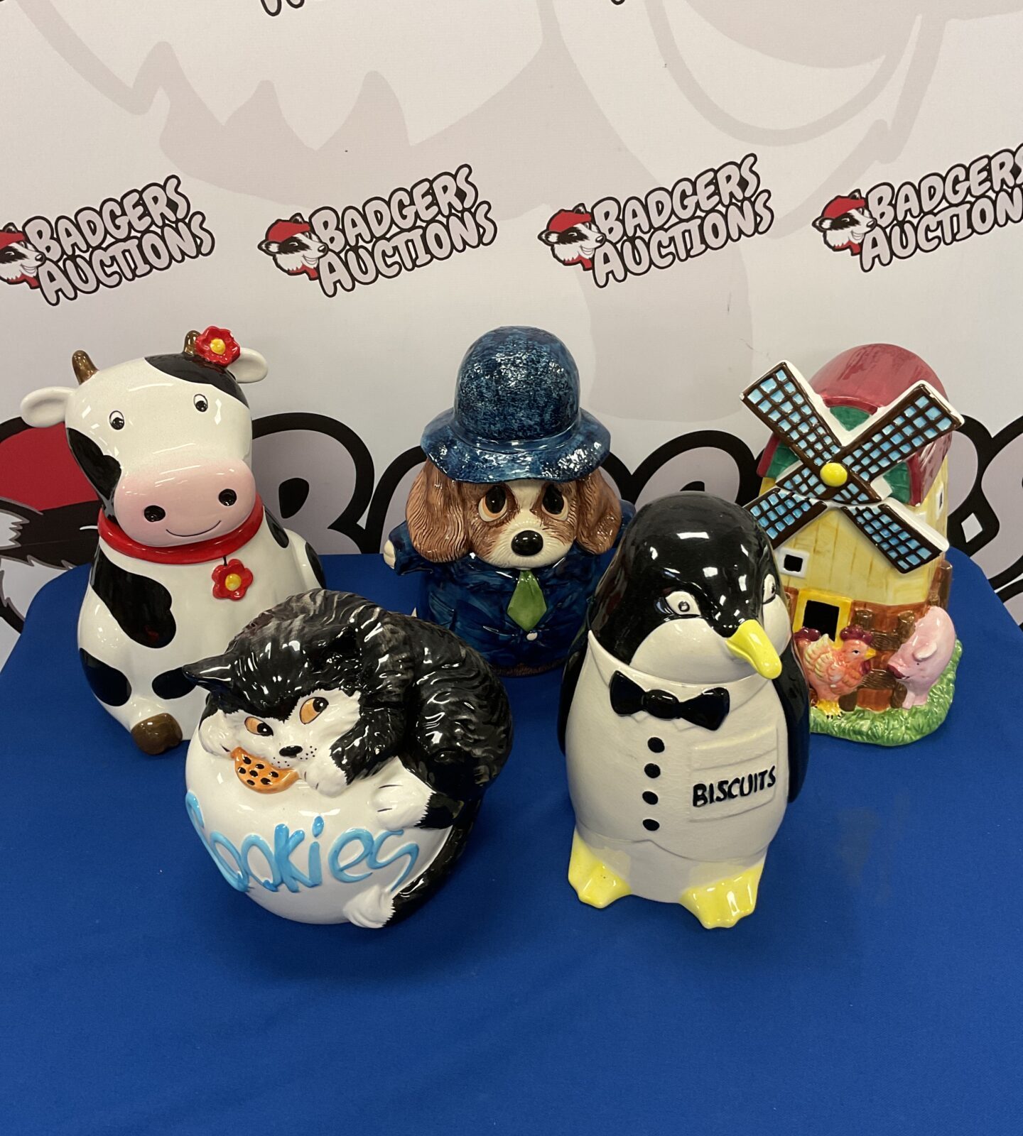 Five ceramic cookie jars including penguin & cow