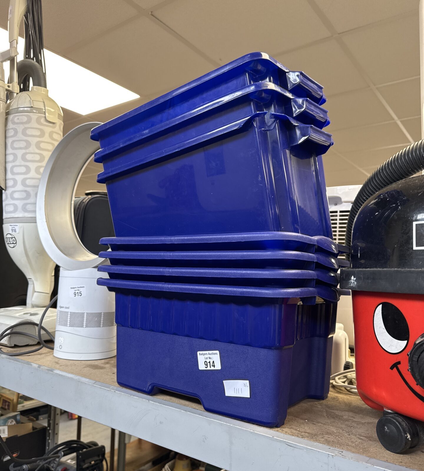 Seven small plastic storage containers