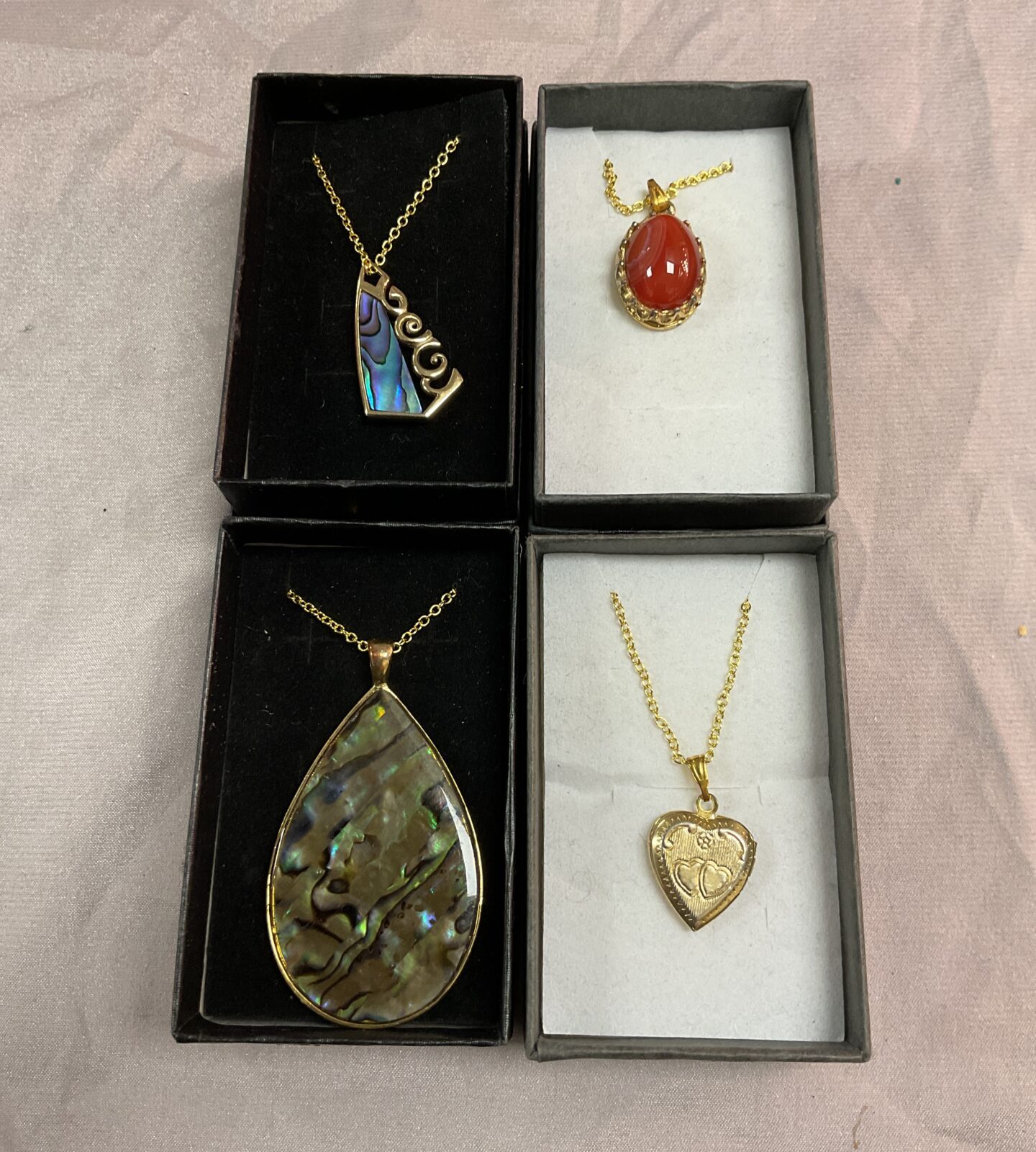four silver gilt pendant neclaces