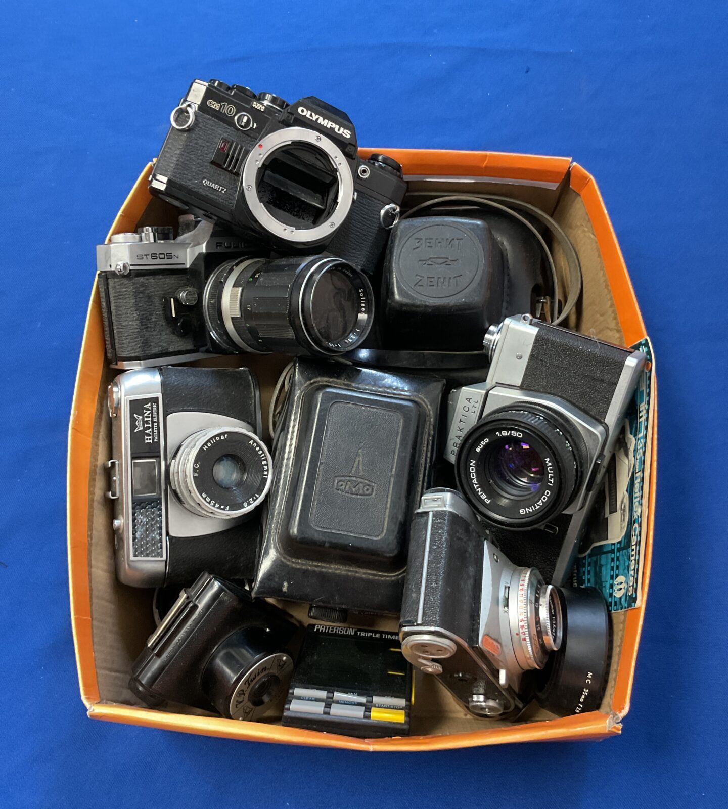 Box of vintage cameras inc Olympus om10
