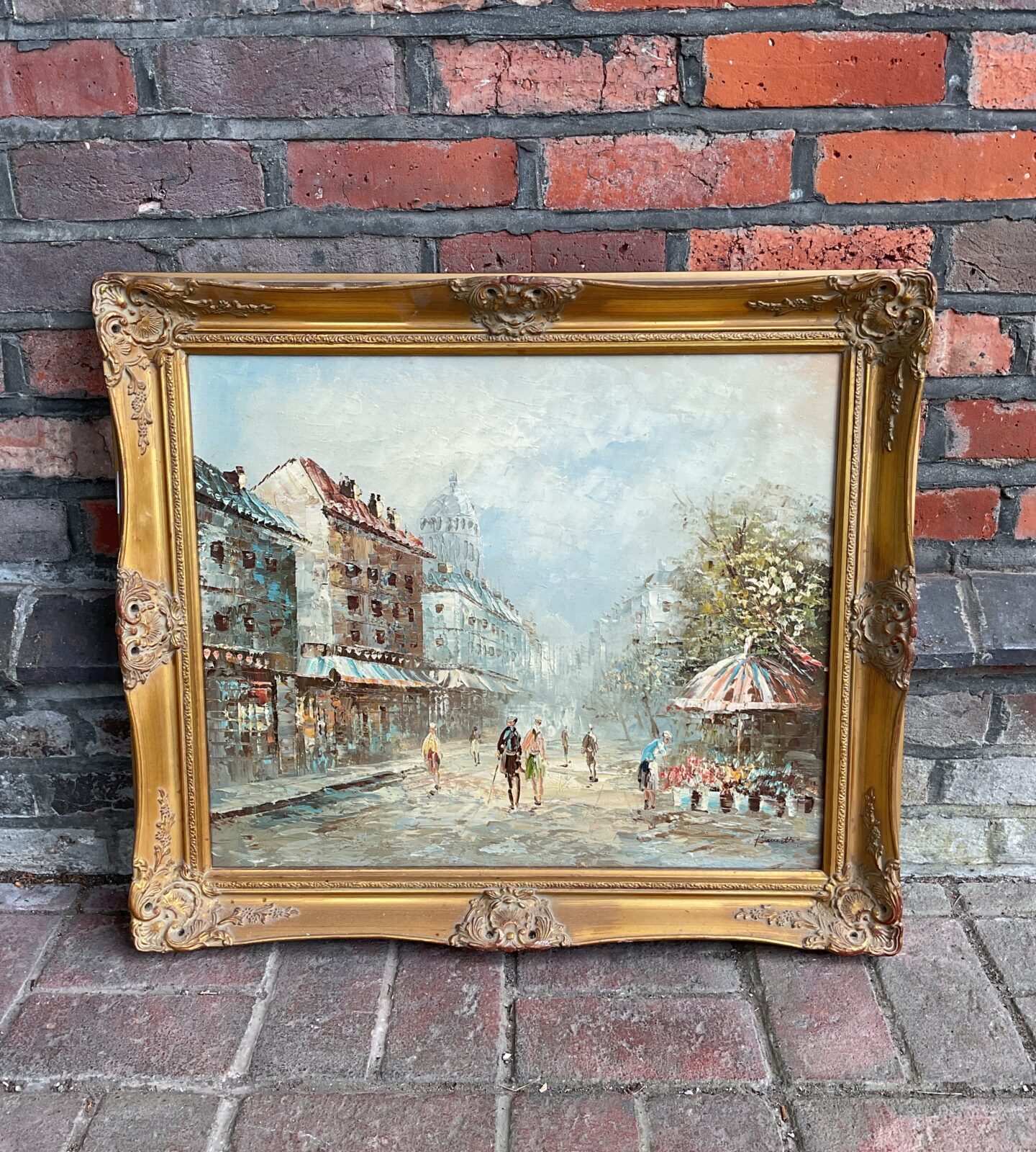 Brunette signed gilt framed oil painting of a french street scene