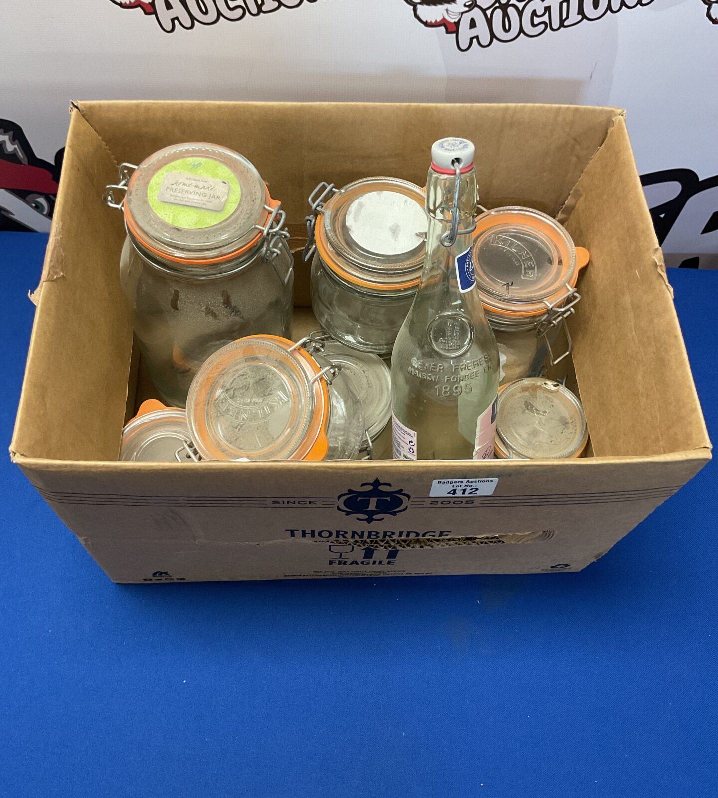 Box of empty reusable bottles and jars inc kilner
