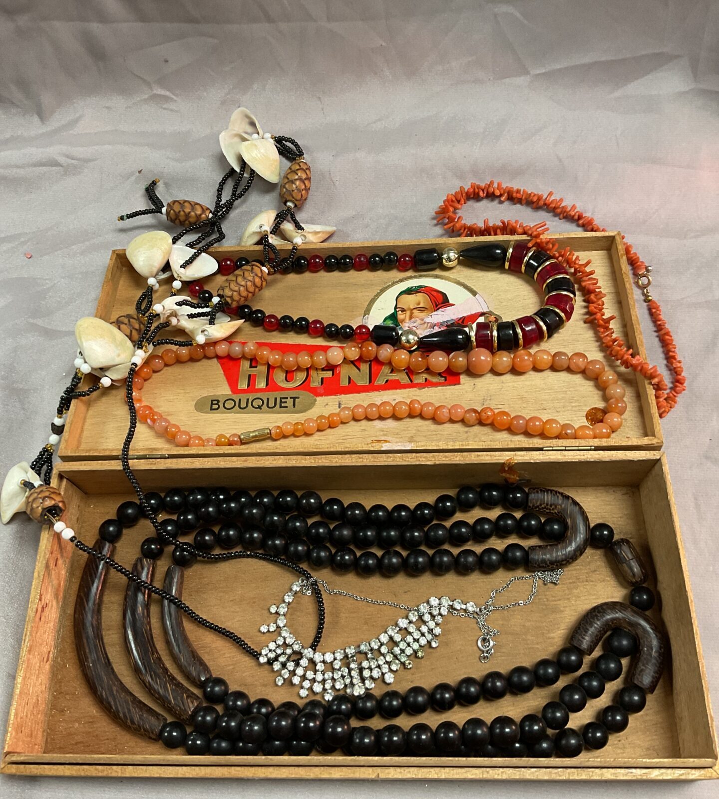 Cigar box of chunky stone and coral necklaces