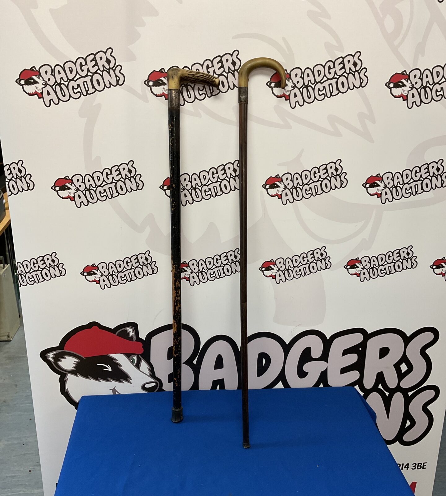 Two horn handled walking sticks with silver cuffs