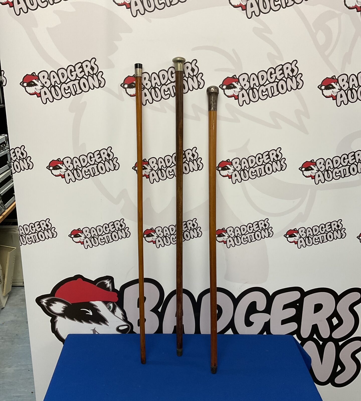 Three vintage walking sticks with silver knops