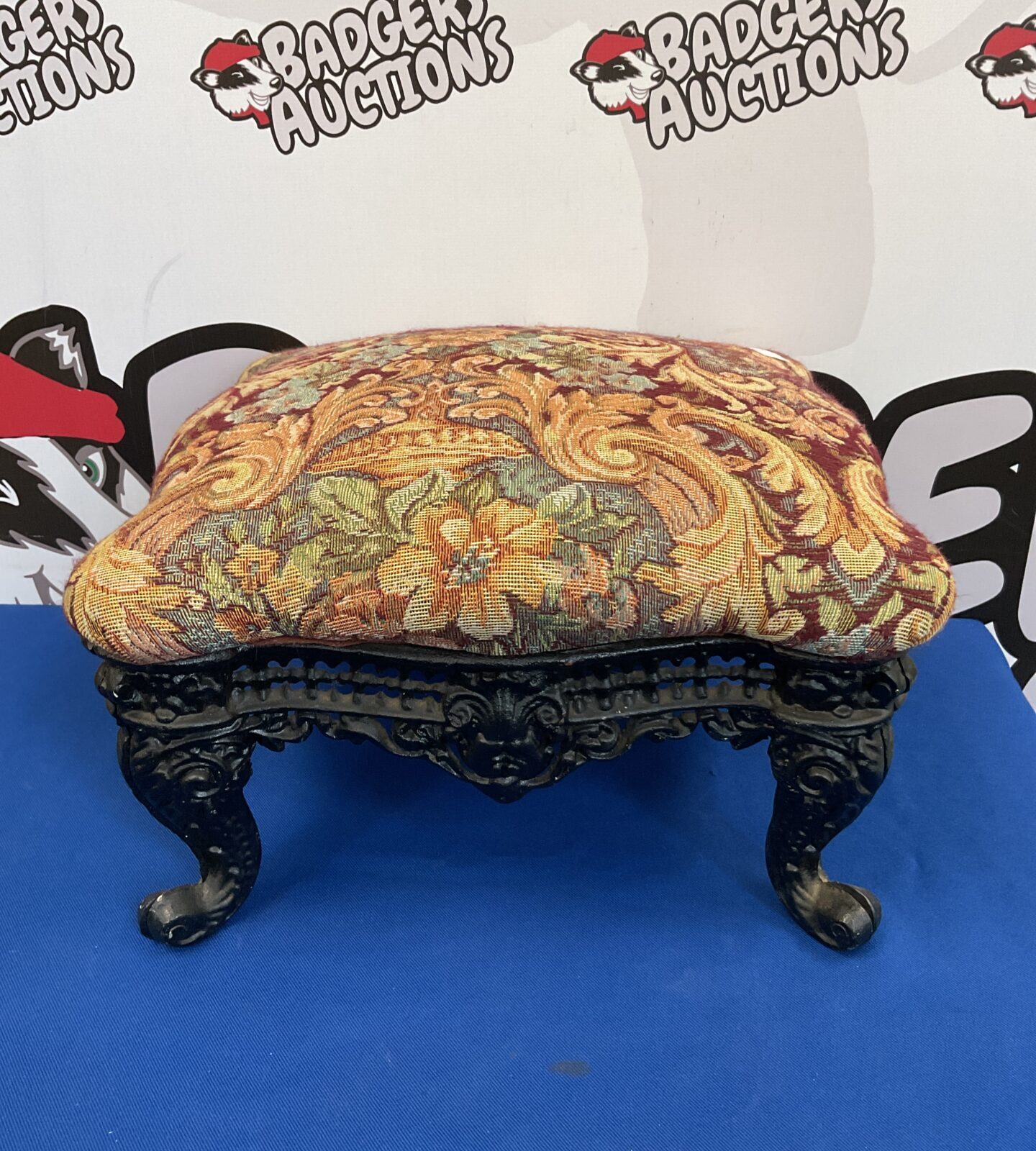 Cast iron footstool with fabric top