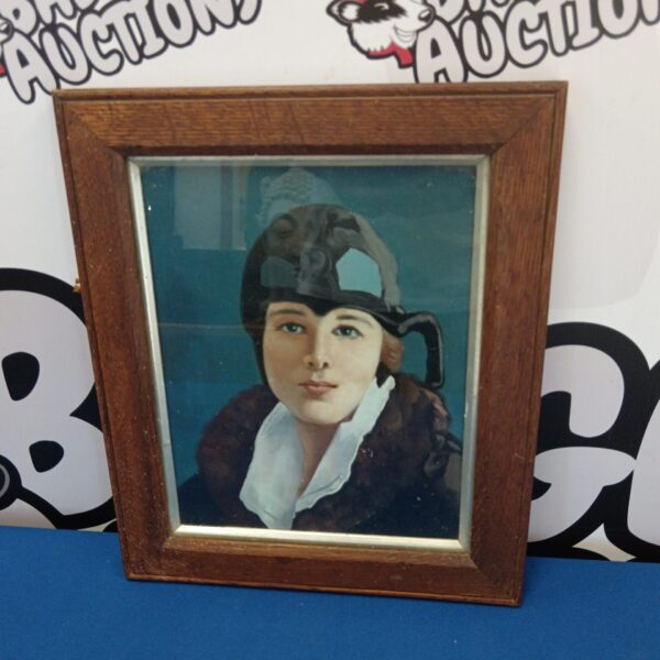 Vintage oil painting of Amelia Earhart in an oak frame.