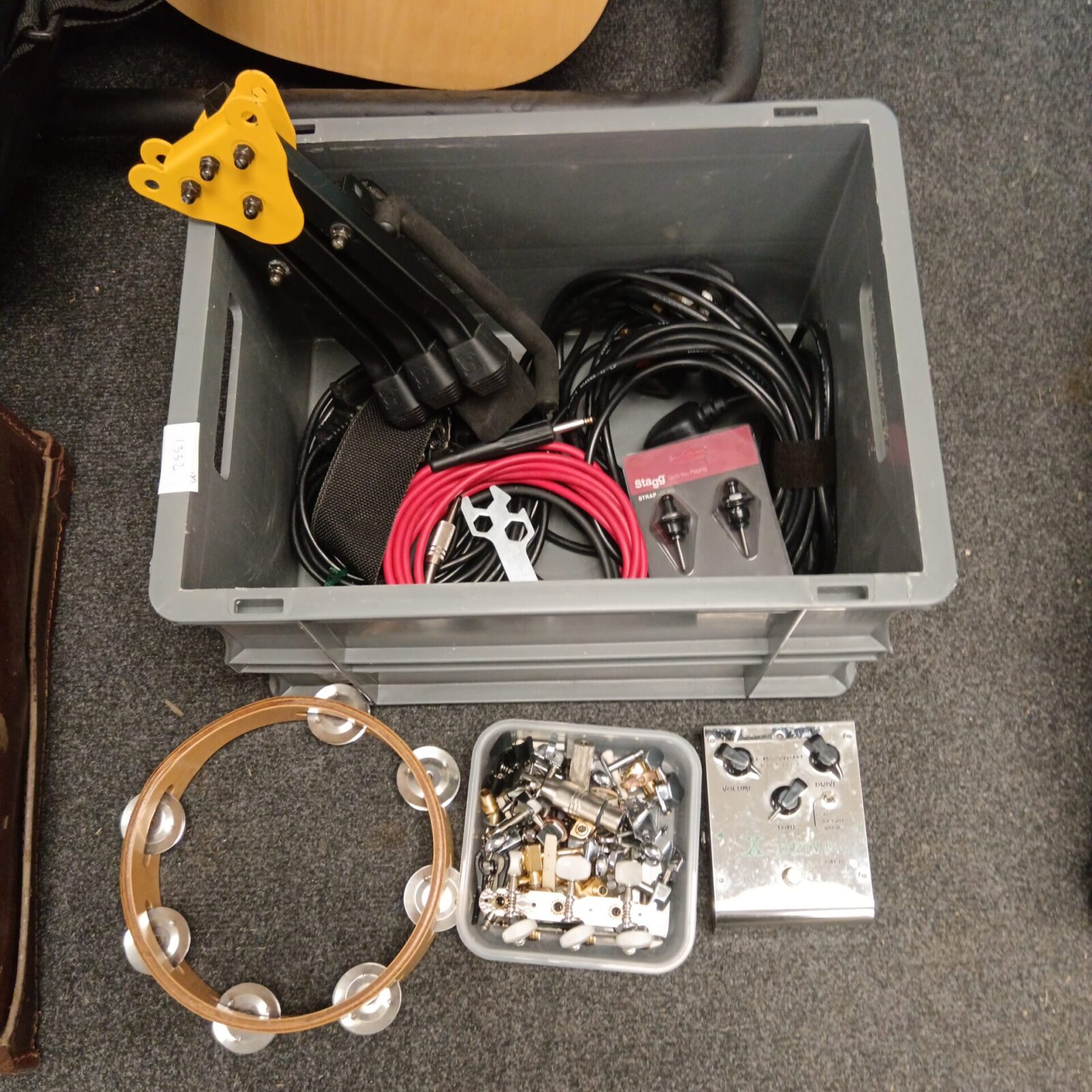 Box of music items including tambourine & x-drive od-8 guitar pedal