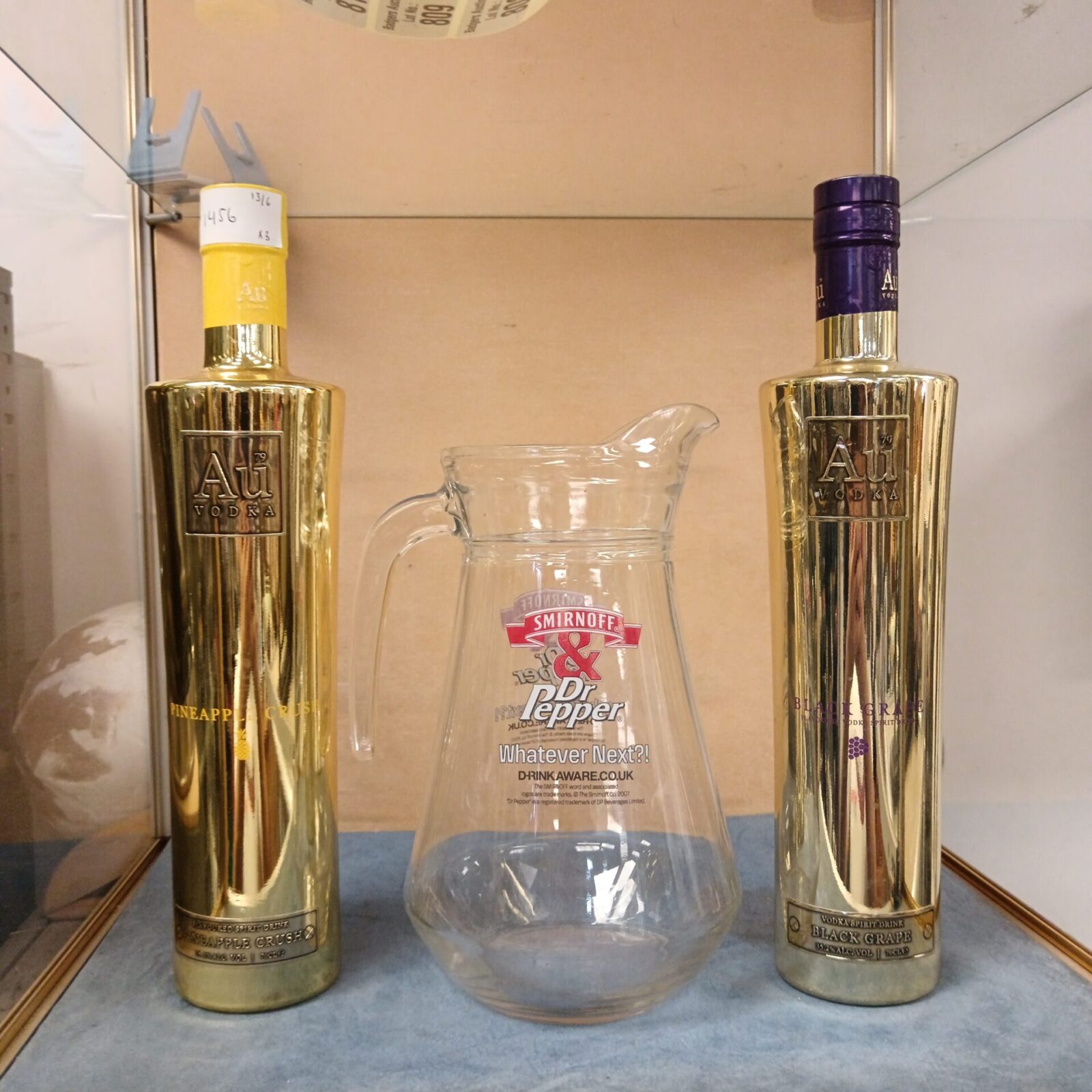 Two sealed bottles of au vodka & Smirnoff & doctor pepper pitcher