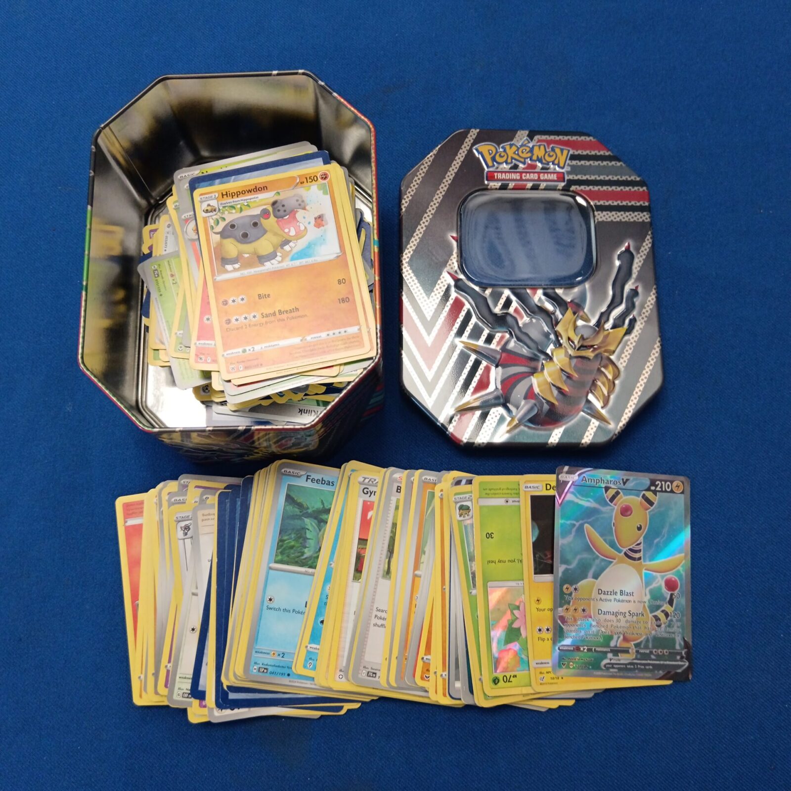 Tin of Pokémon cards including holos