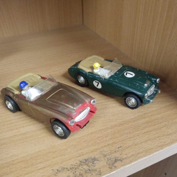 Two vintage scalextruc Austin Healey slot cars