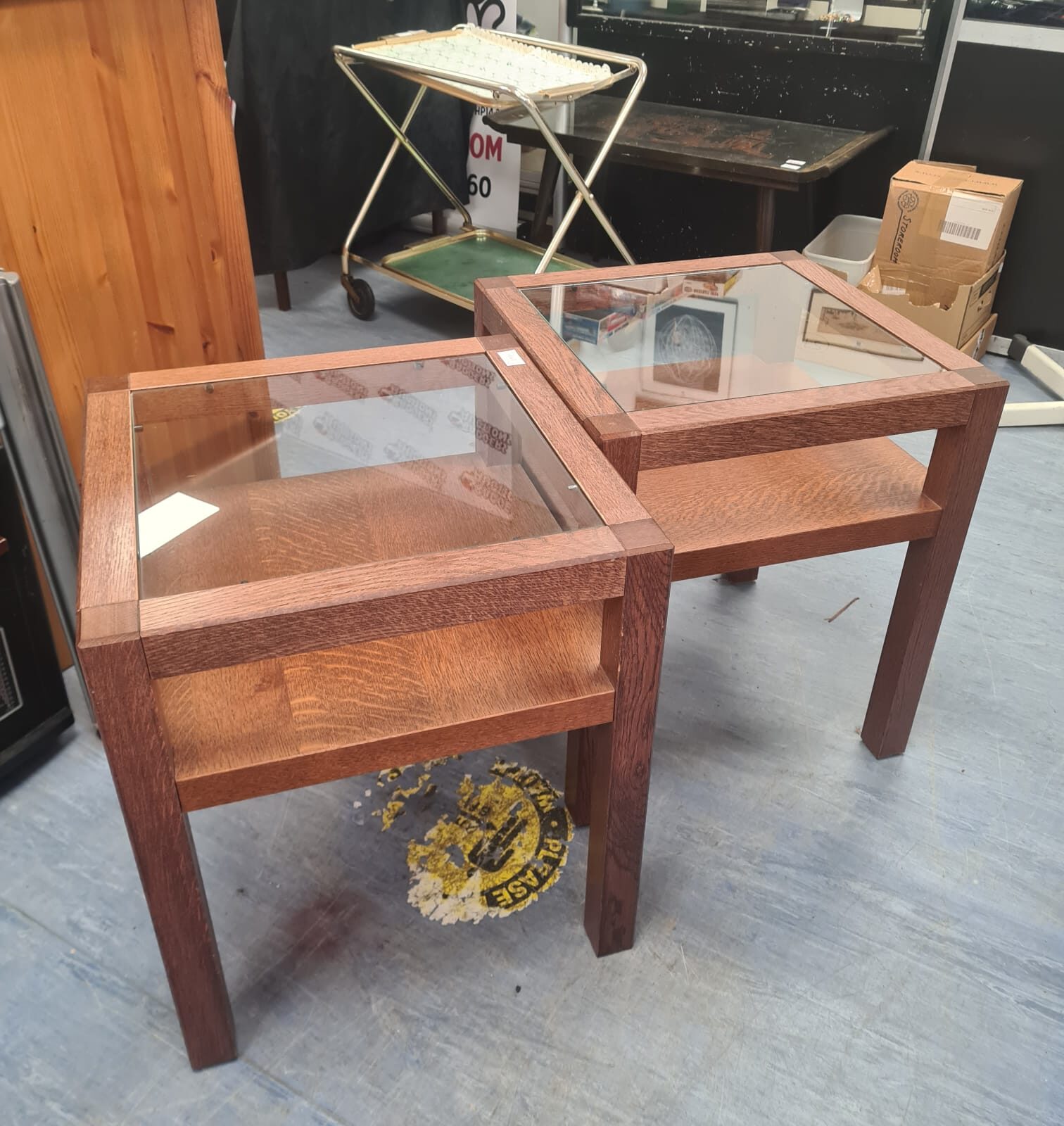 Two glass topped oak coffee tables