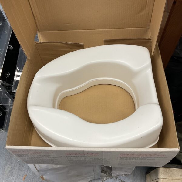 New Homecraft raised toilet seat in original packaging.