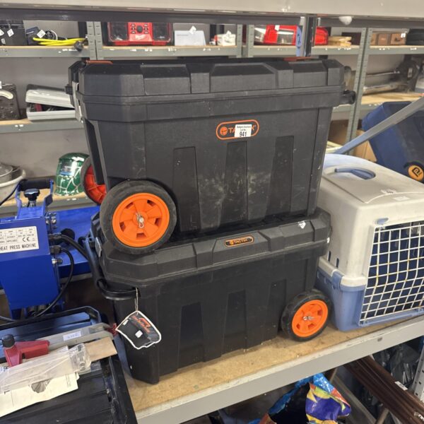 Pair of black Tactix wheeled toolboxes with wheels and handles.