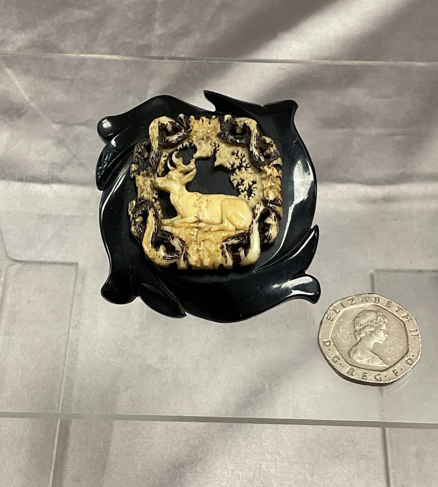 Victorian jet and bone brooch featuring a carved stag