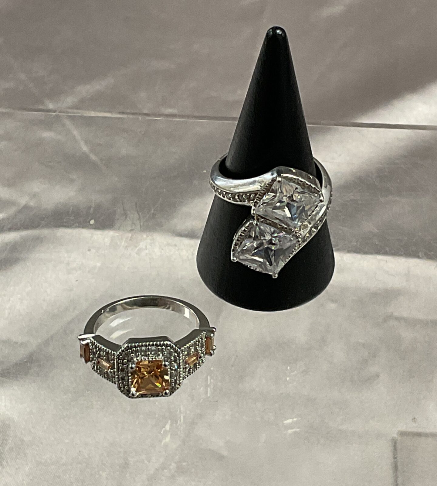 Two 925 silver crossover ring set with white stones and one set with yellow stone size n