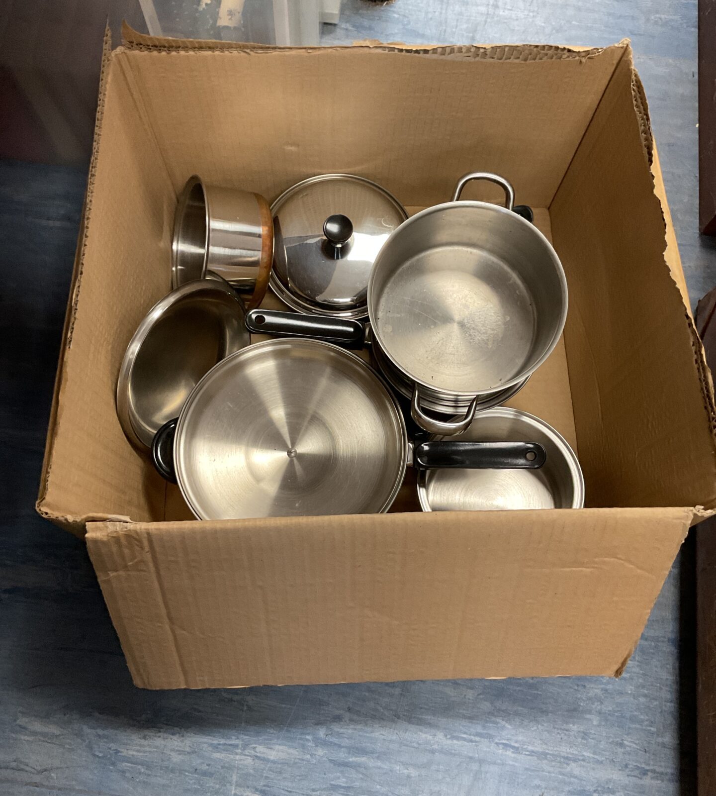 Box of stainless steel pots and pans