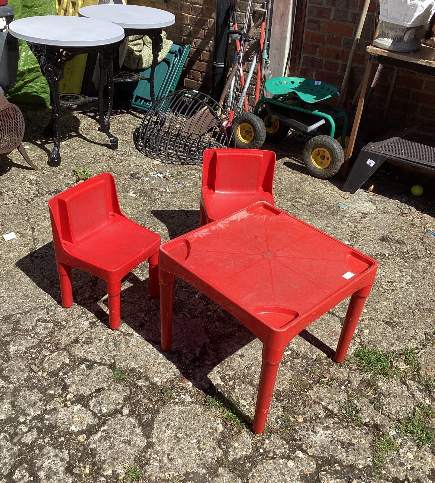 Red plastic childs garden table and chairs