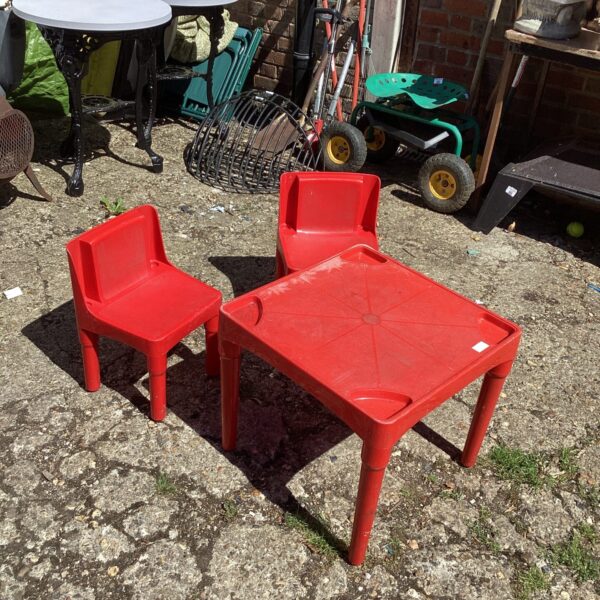 Red plastic childs garden table and chairs