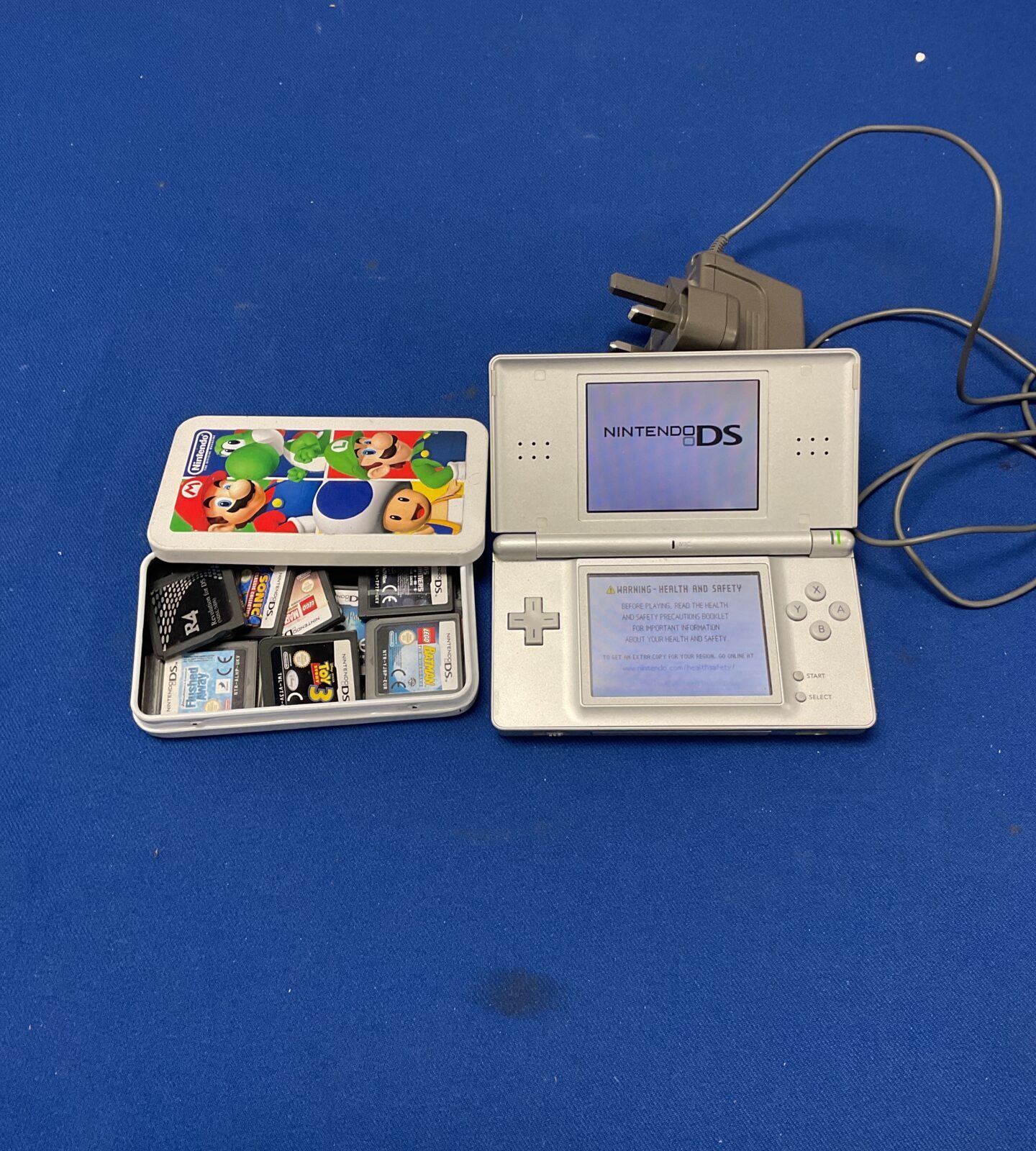Nintendo DS with charger and games incl. sonic, lego batman, lego marvel superheros