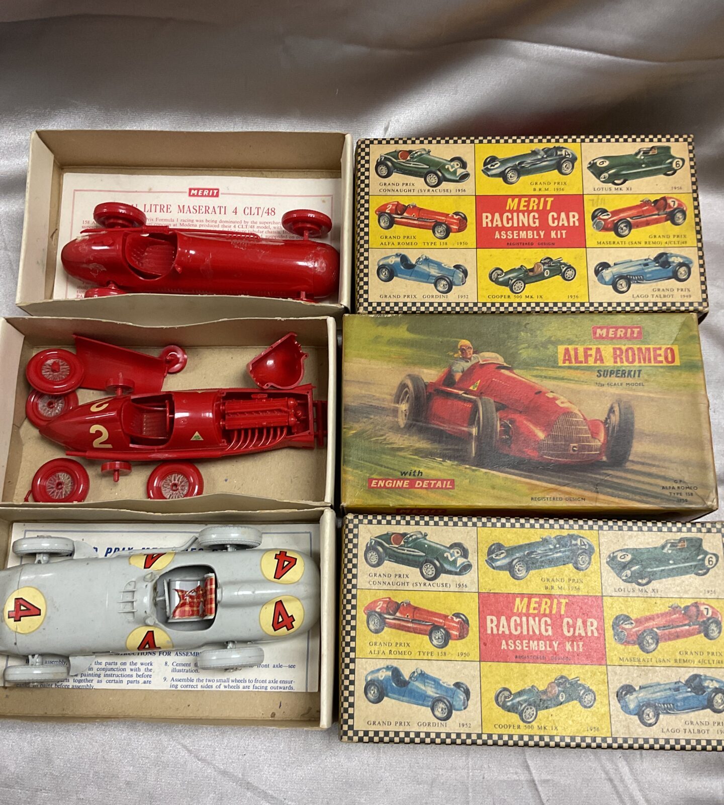Three vintage merit model car kits part made