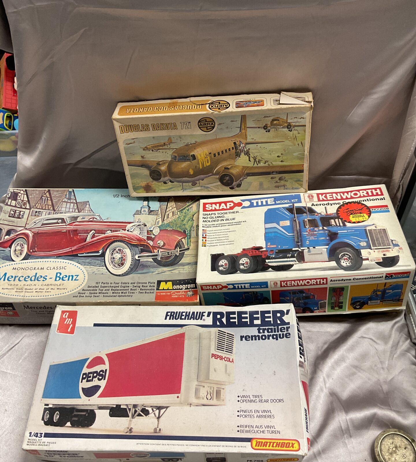 Four vintage model kits Inc monogram Mercedes Benz and kenworth truck some part made