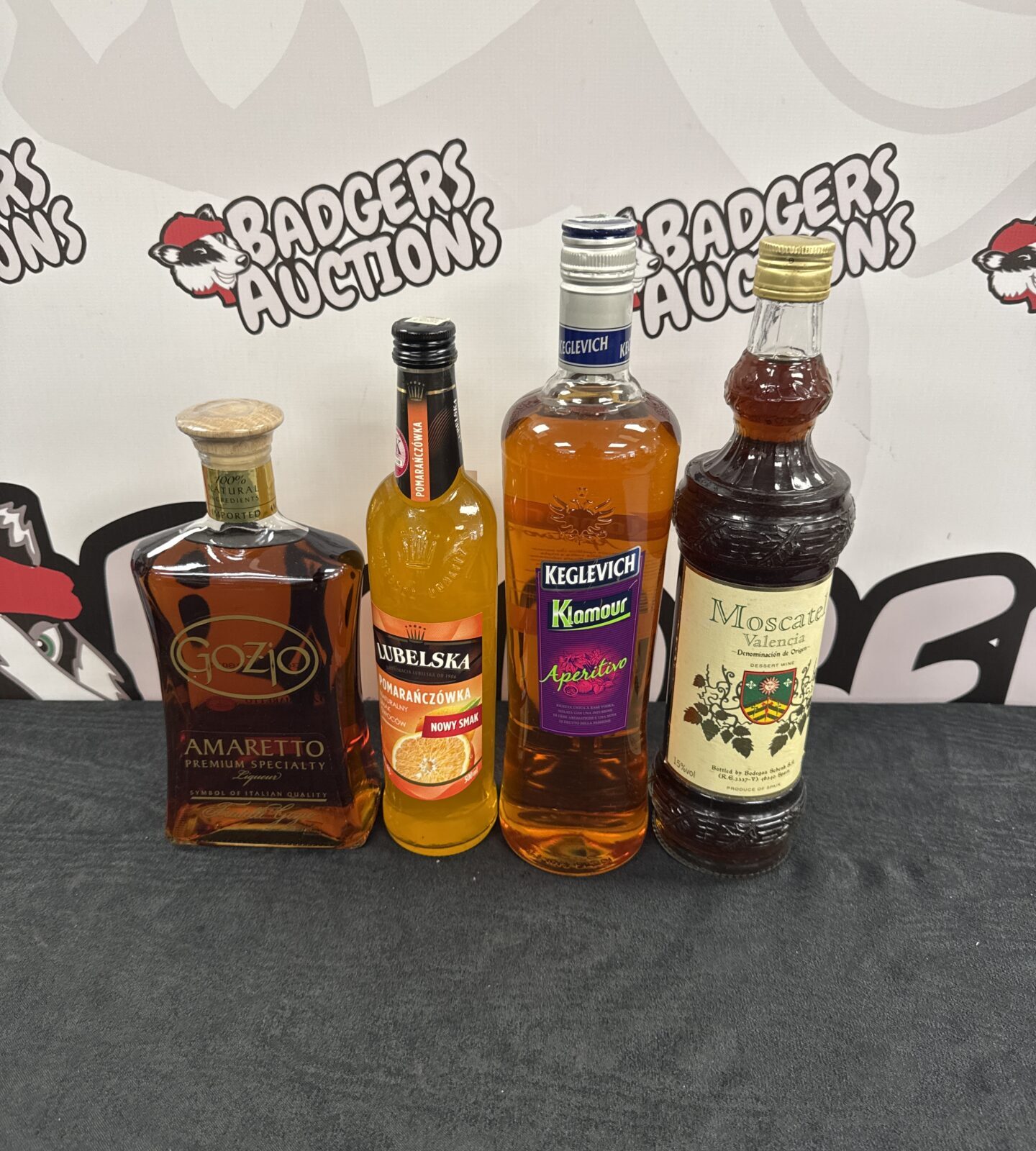 Four bottles of alcohol including amaretto & others