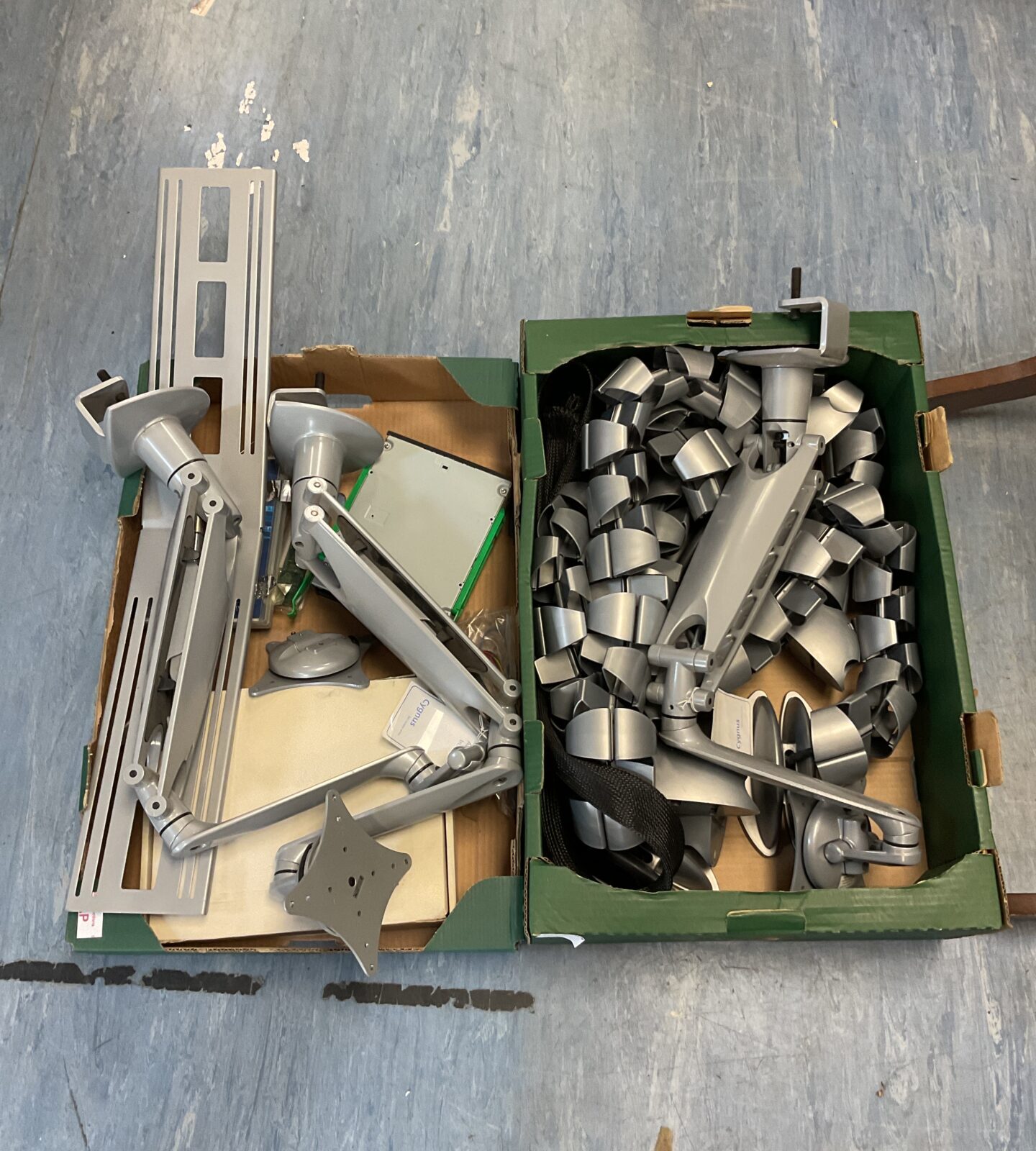 Two trays of computing accessories including screen mount & cable tidy