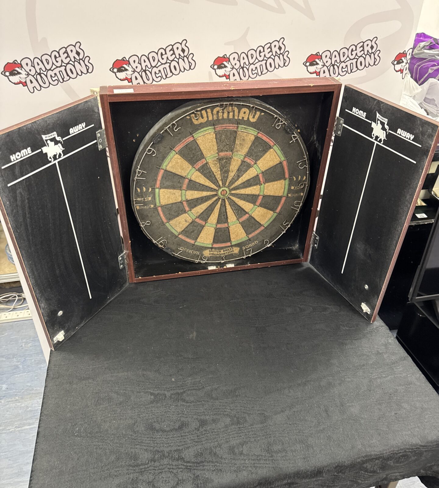Used winmau dartboard in wooden wall case