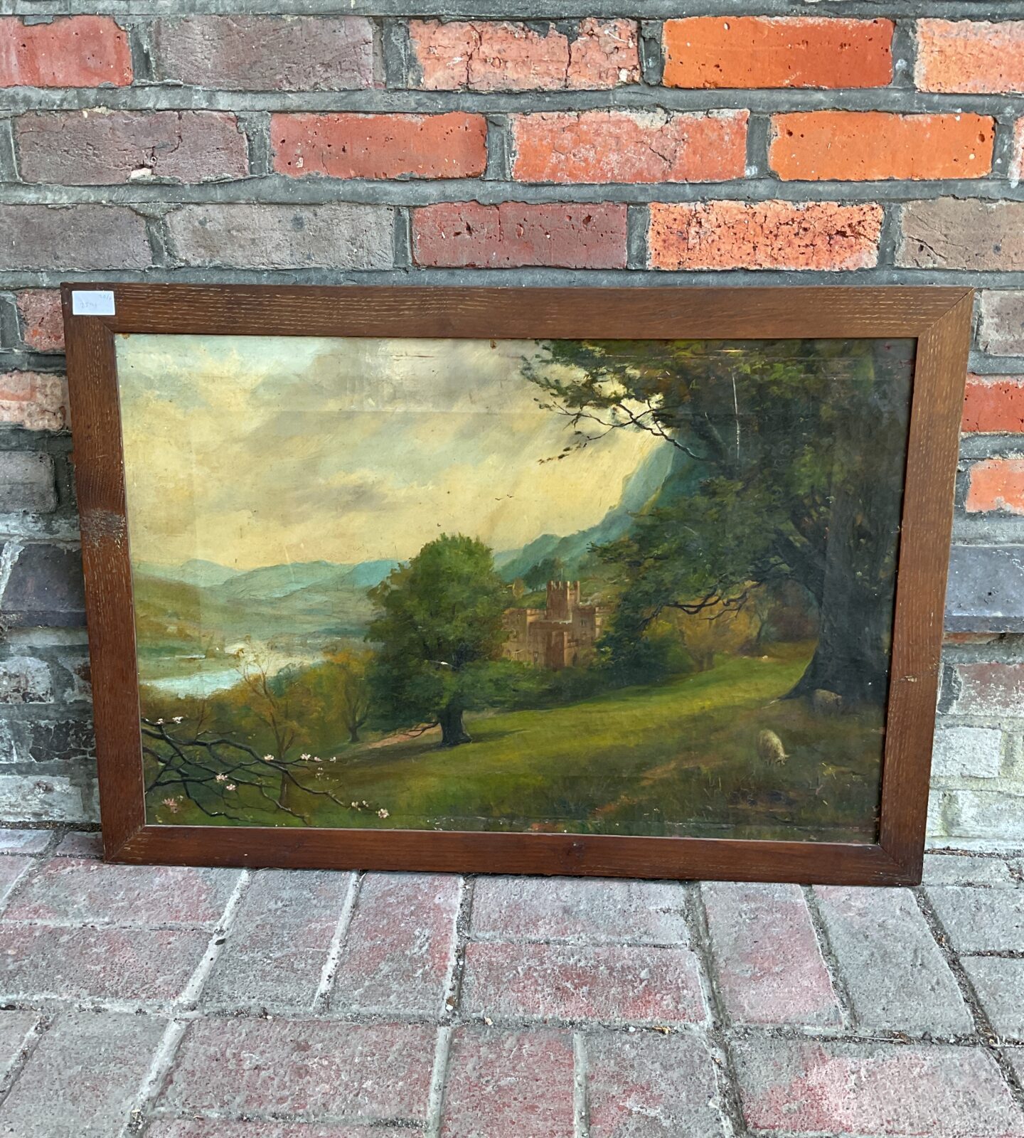 19th century oil on canvas painting of a manor house in a mountainous landscape