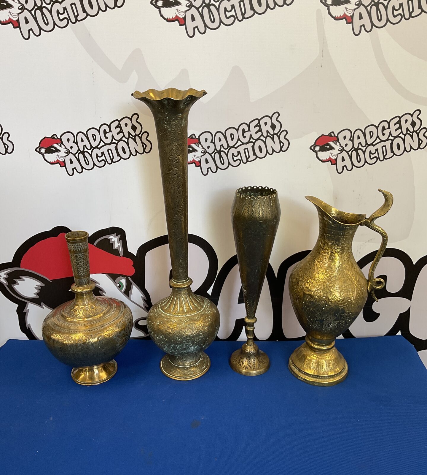 Three heavily engraved indian brass vases with pitcher