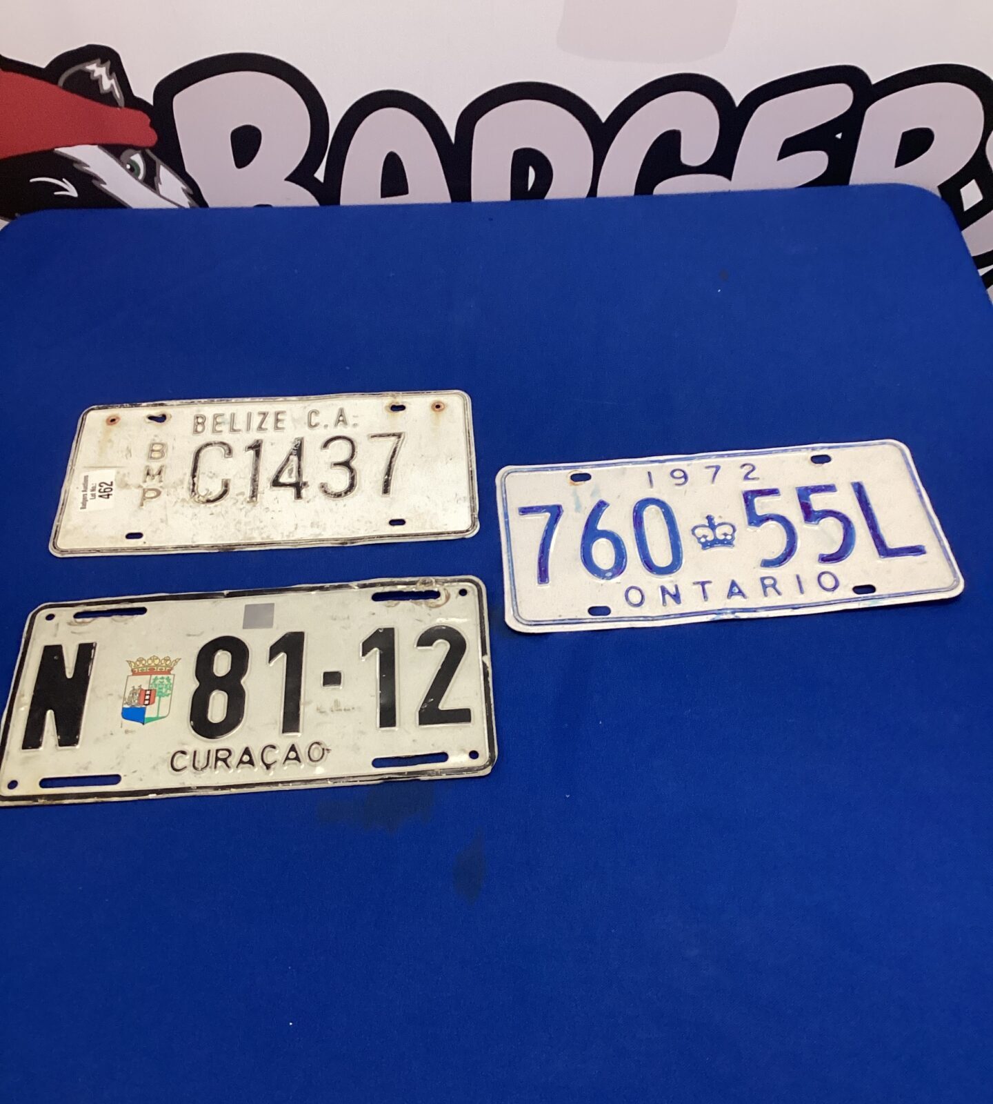 Three old tin licence plates