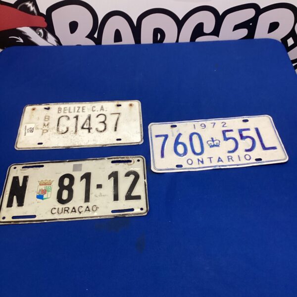 Three old tin licence plates