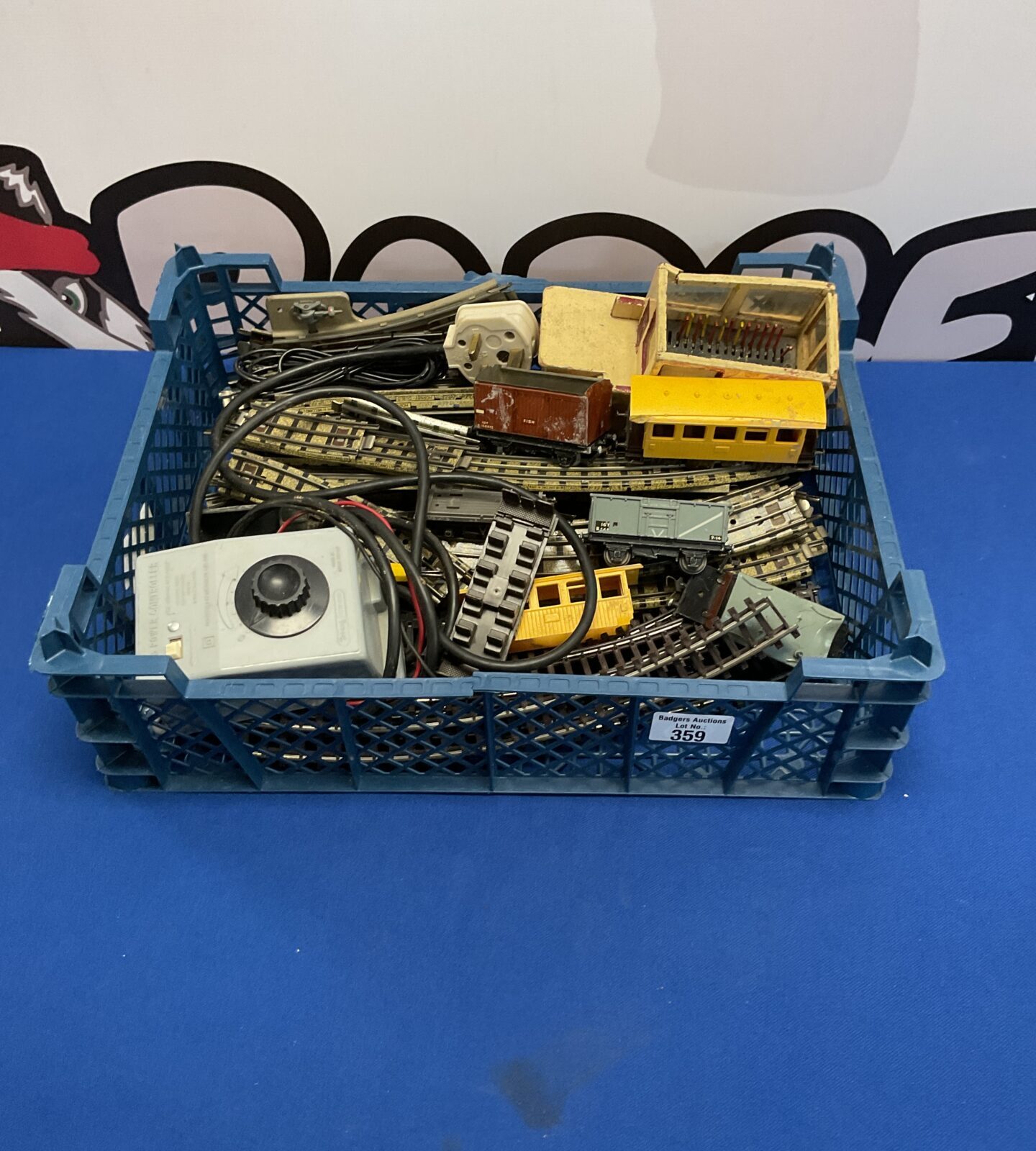 Crate of vintage hornby three rail tracks, carriages, accessories and power controller