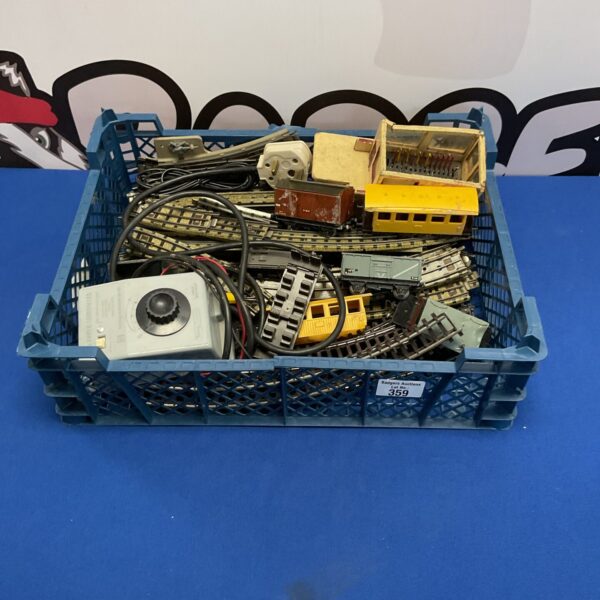 Crate of vintage hornby three rail tracks, carriages, accessories and power controller