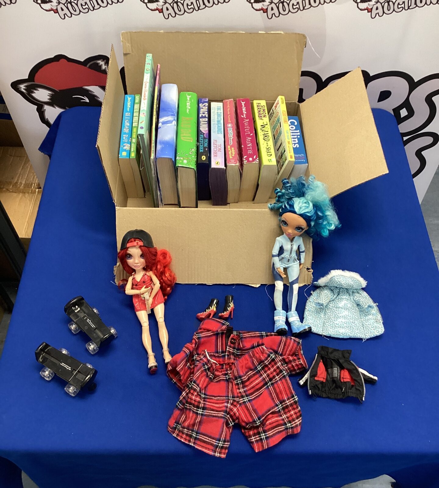 box of children's books With two dolls