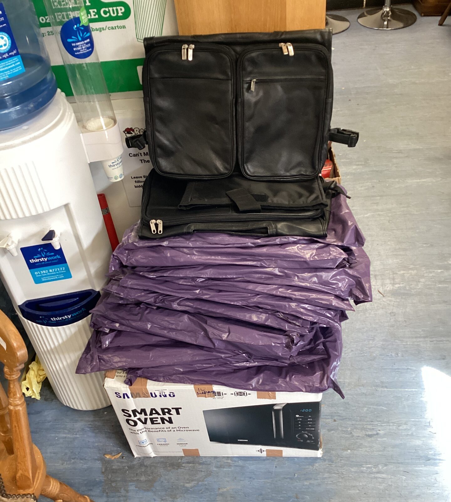 Large quantity of black leather bags